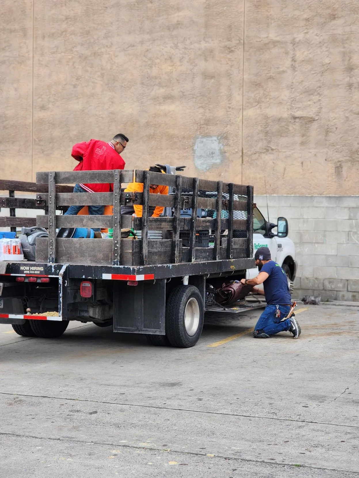 Volunteer workers unloading flooring materials